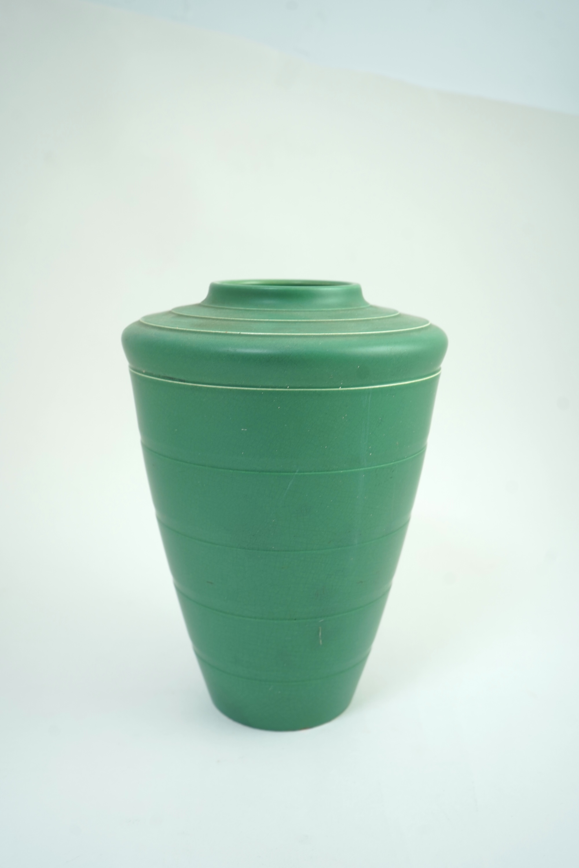Keith Murray MC RDI FRIBA (New Zealand/British, 1892-1981) for Wedgwood: A matt green glazed tapering vase